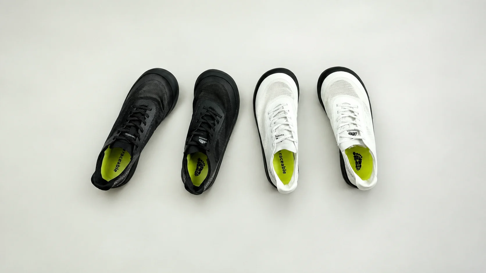 Black and white Traceable barefoot shoes arranged on a light background